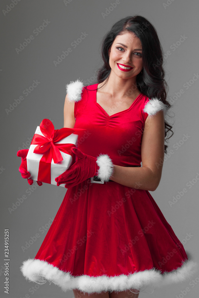 Woman in santa dress with gift Woman in santa dress with gift
