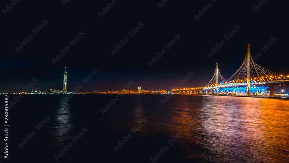 Obraz premium SAINT-PETERSBURG, RUSSIA - november 21, 2018: Time lapse evening highway, western high-speed diameter at sunset. Blurry cars on long exposure, Vasilievsky Island
