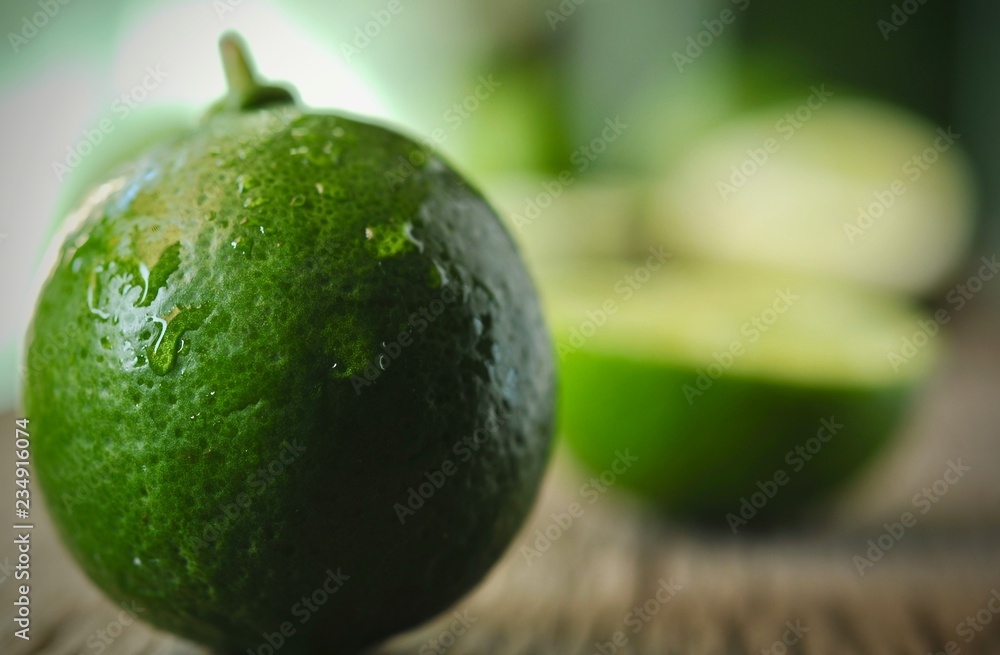 limes slices on wooden table. Detox diet, fresh lime Background, Close up shot, fruit macro photography limes slices on wooden table. Detox diet, fresh lime Background, Close up shot, fruit macro photography