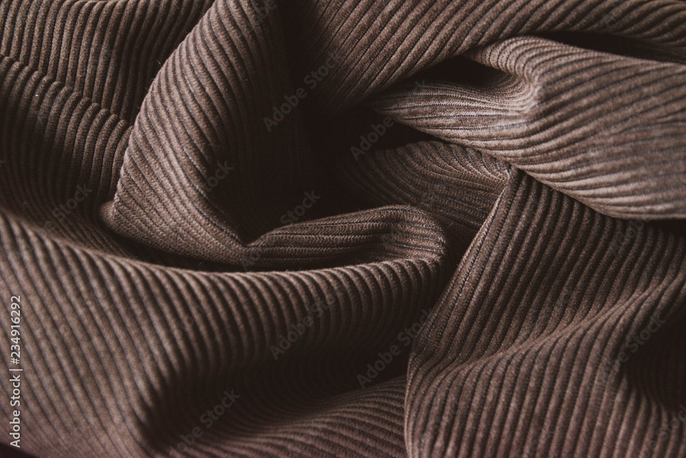 abstract brown ribbed corduroy background. velvet fabric texture Stock