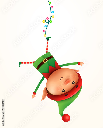 Little elf hanging upside down. Isolated. photo