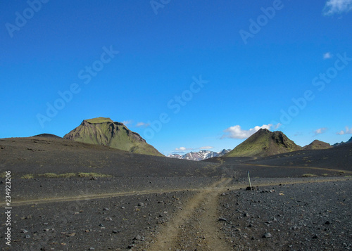 Walking path throw volcanic black sand desert landscape  Laugavegur Trail from Thorsmork to Landmannalaugar  Highlands of Iceland