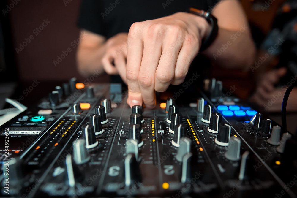 DJ sound equipment at nightclubs and music festivals, EDM, future house music and so on. Parties concept, sound technique. DJ playing on the best DJ sound equipment at nightclubs and music festivals, EDM, future house music and so on. Parties concept, sound technique. DJ playing on the best