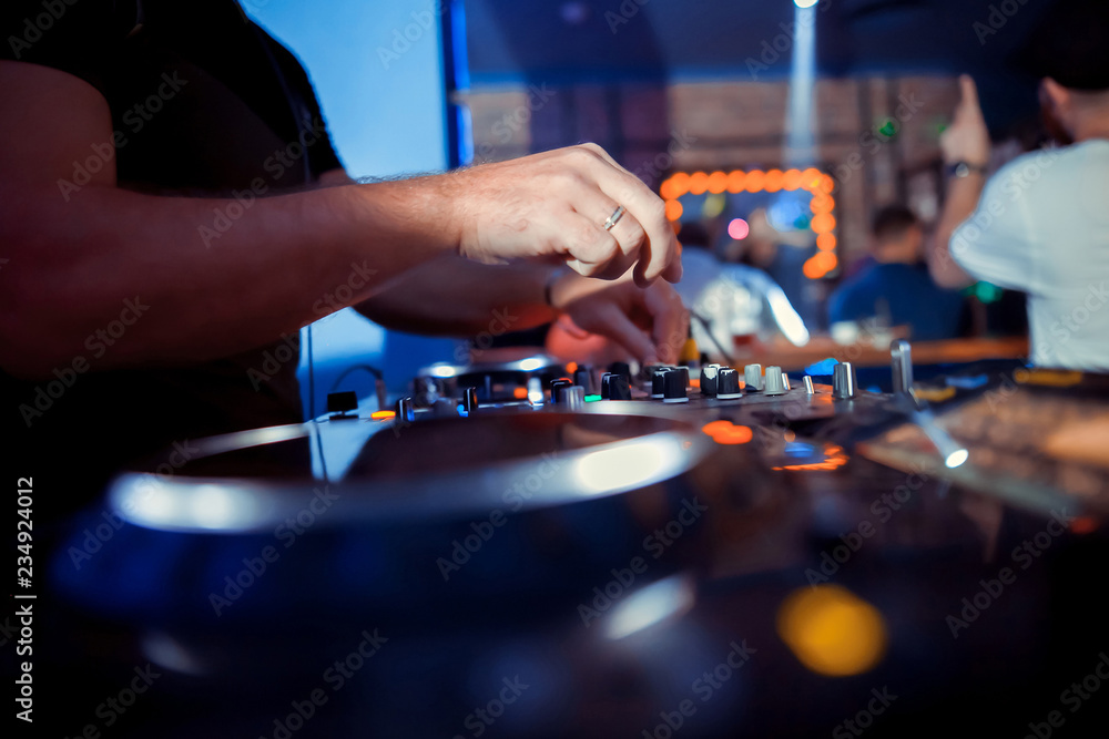 DJ sound equipment at nightclubs and music festivals, EDM, future house music and so on. Parties concept, sound technique. DJ playing on the best