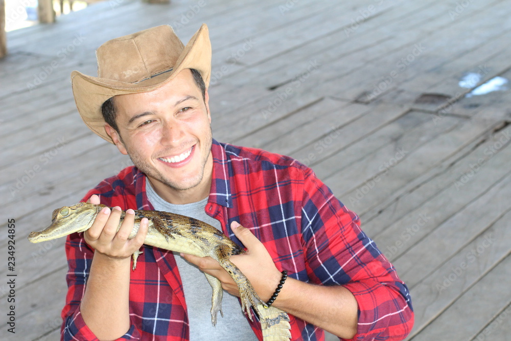 Fototapeta premium Indigenous man holding a caiman