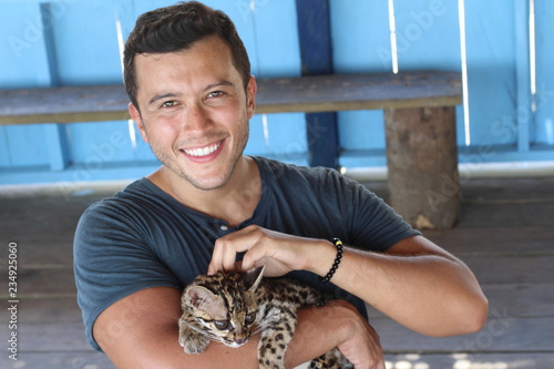 Animal tamer holding a gorgeous ocelot