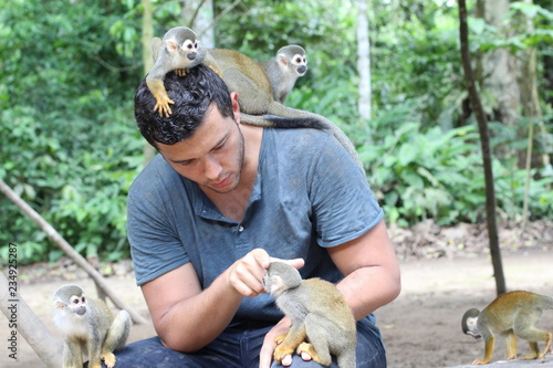 Photography Handsome ethnic man with titi monkeys