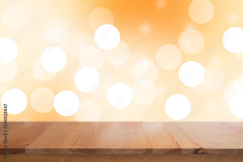 Wooden desk with Gradient Abstract Blurred orange tone lights background Wooden desk with Gradient Abstract Blurred orange tone lights background