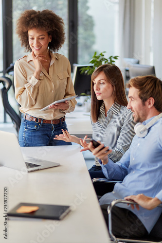 Startup concept - creative team talking in office