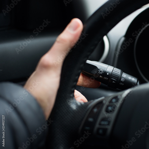Hand on the steering wheel, close-up © mischenko