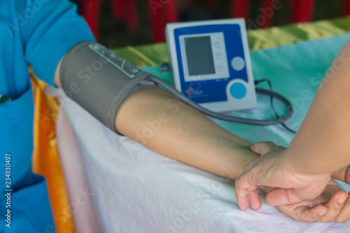 Nurse measuring blood pressure to patient