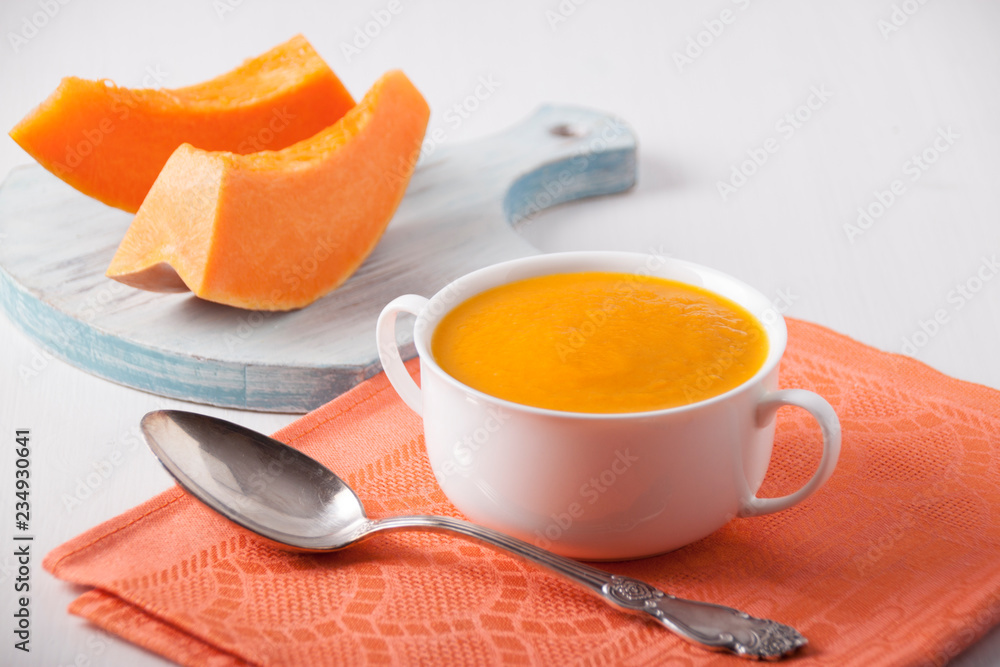 Pumpkin cream soup in a white plate Pumpkin cream soup in a white plate