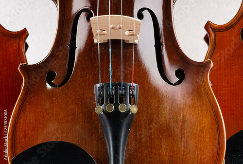 Closeup half front side of violin put on background,show detail and part of violin