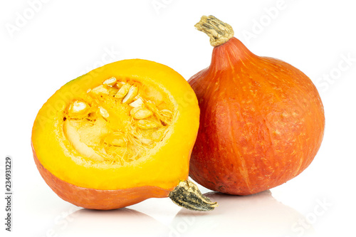Group of one whole one half of fresh red kuri pumpkin hokkaido variety with seeds isolated on white background
