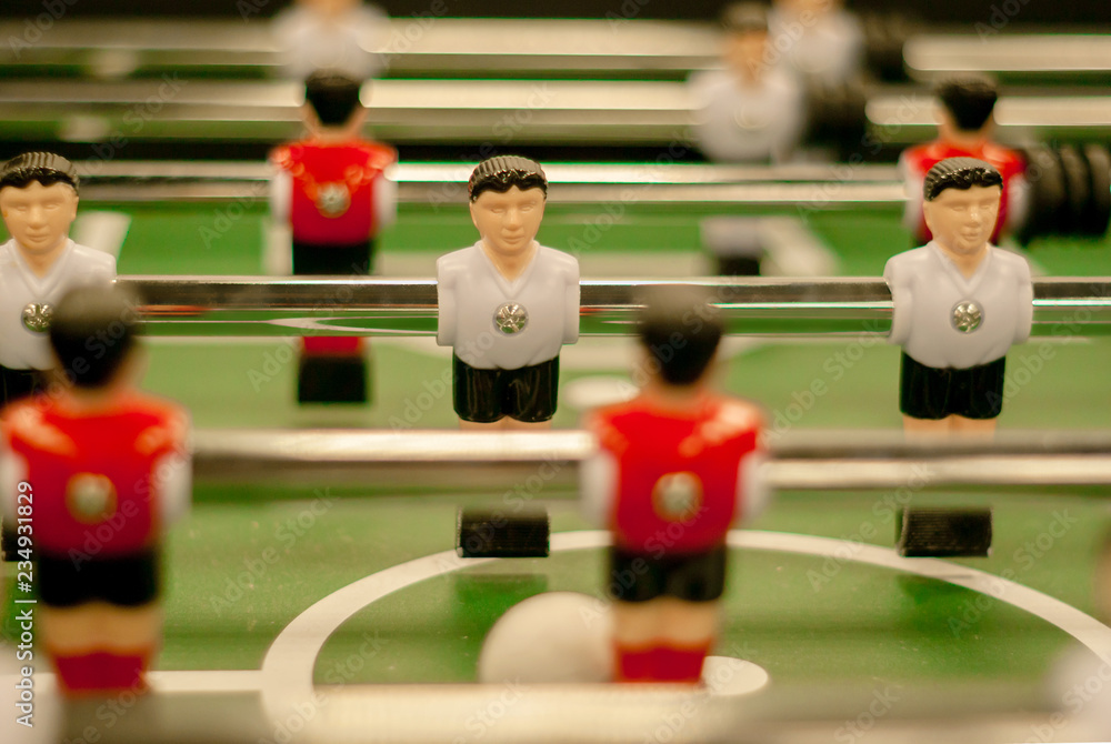 classic foosball, a fragment of the playing field with two rows of player figures close-up classic foosball, a fragment of the playing field with two rows of player figures close-up