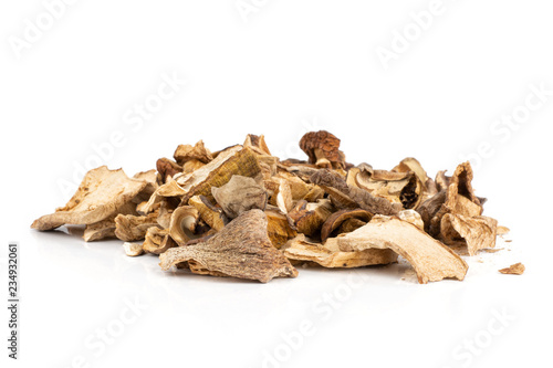 Lot of slices of dry brown mushroom boletus edulis variety heap isolated on white background