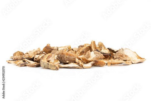 Lot of slices of dry brown mushroom boletus edulis variety stack isolated on white background