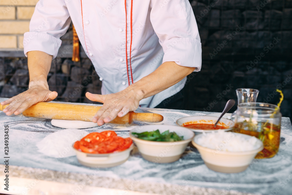 Cooking Pizza. Pizza ingredients on the  table.