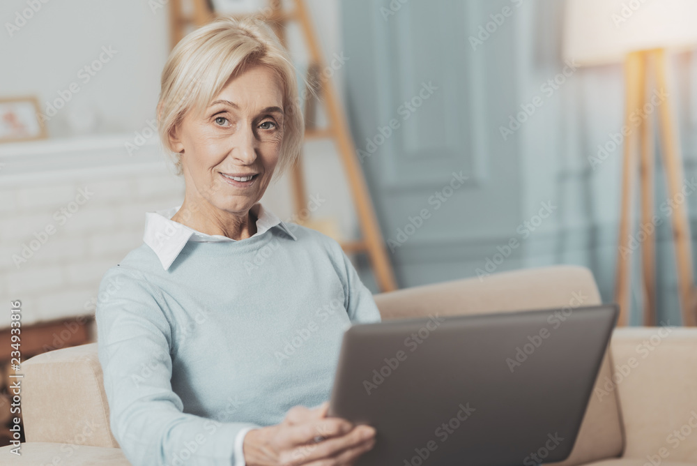 Delighted aged woman working on the laptop Delighted aged woman working on the laptop
