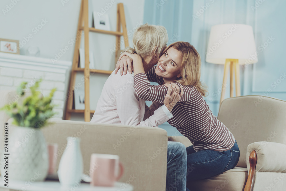 Young woman hugging her mother Young woman hugging her mother