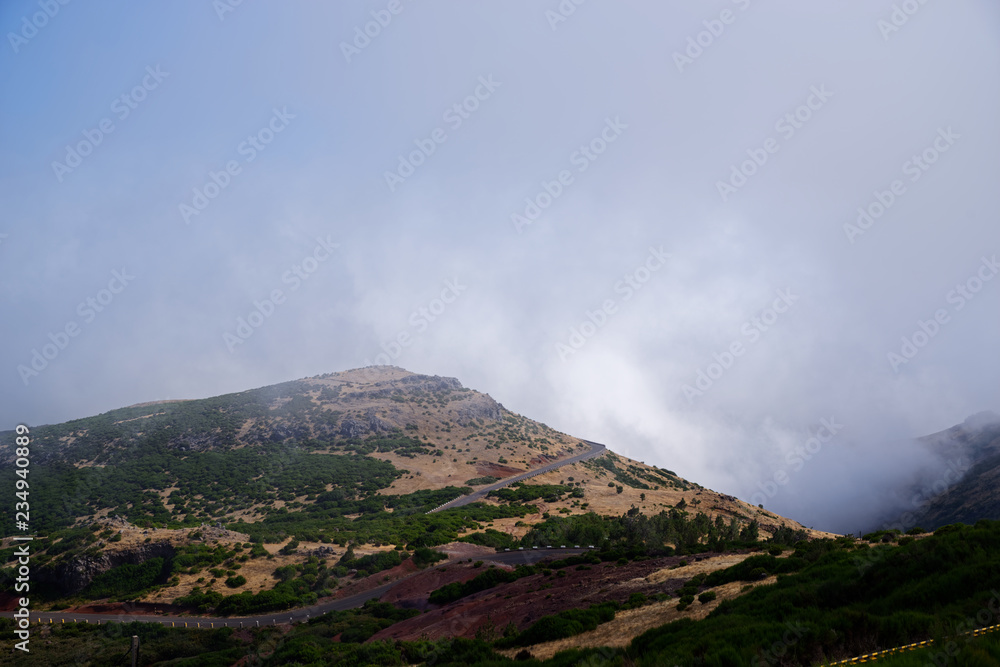 Mountain road against dense clouds Mountain road against dense clouds
