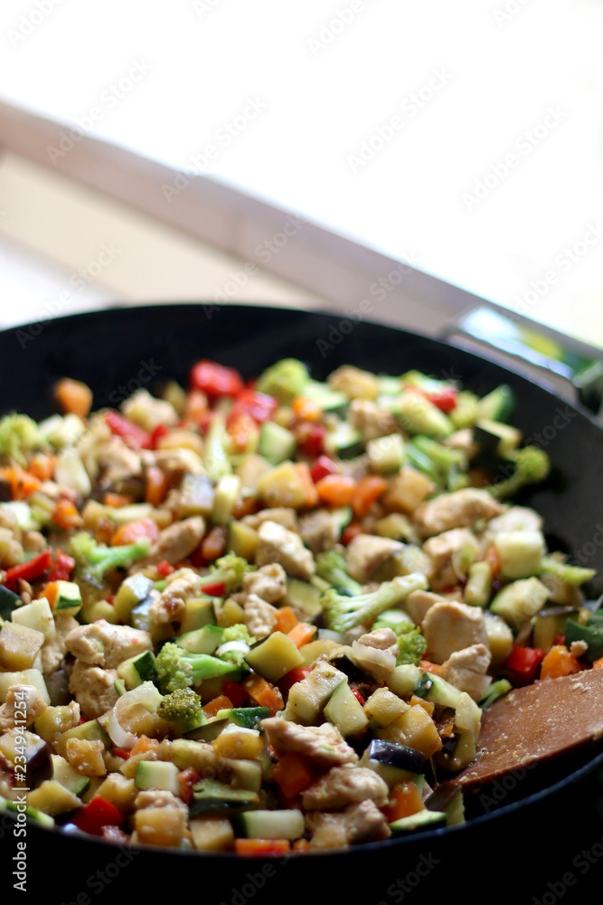 Cooking various vegetables and chicken in wok. Selective focus. Cooking various vegetables and chicken in wok. Selective focus.