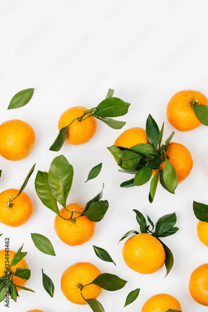 Fresh orange Mandarins, tangerine with green leaves on white background. Flat lay. Top view Fresh orange Mandarins, tangerine with green leaves on white background. Flat lay. Top view