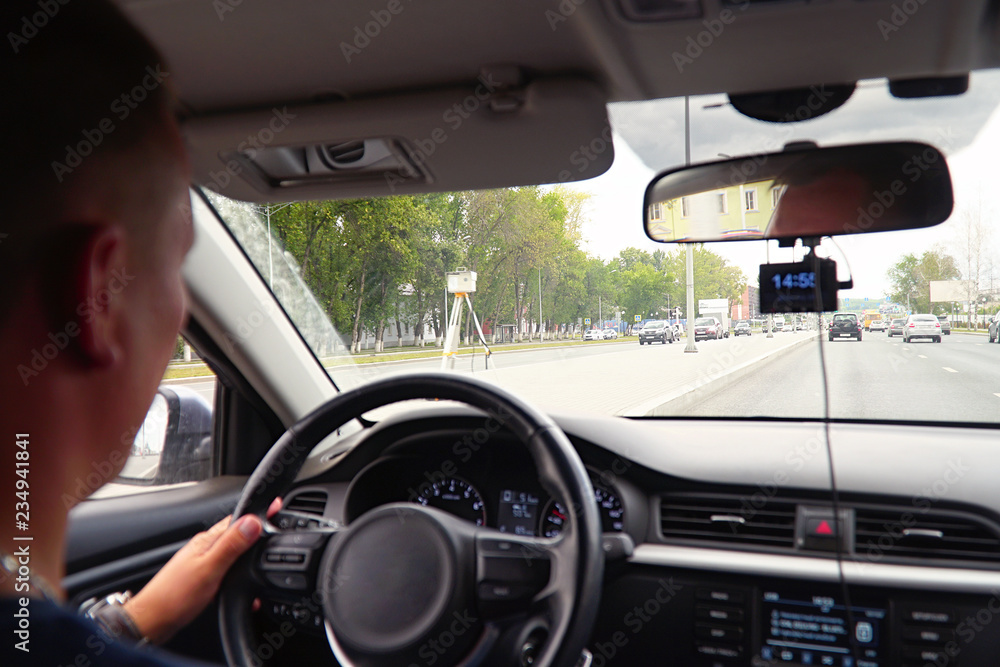 A man driving a car. View from the windshield