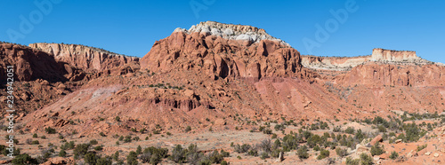 Panorama of a vast landscape of colorful red rock mesas and cliffs in the high desert near Abiquiu, New Mexico in the American Southwest