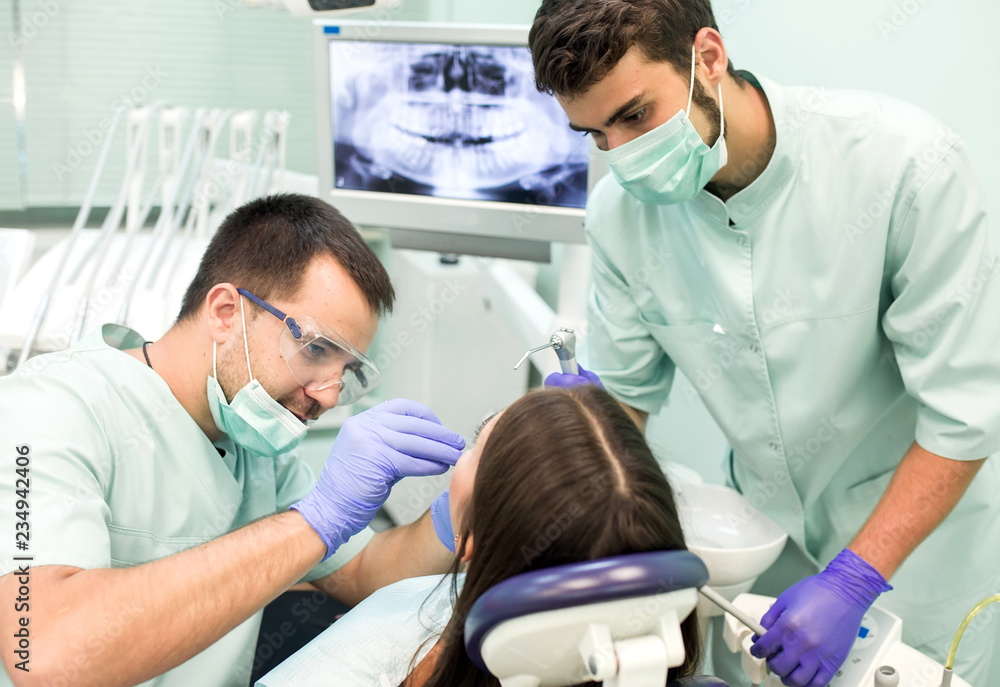 Doctor Dentist with an assistant work in a dental clinic. Doctor Dentist with an assistant work in a dental clinic.