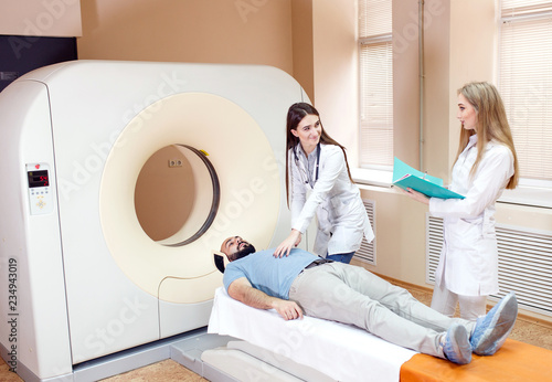 Happy patient undergoing mri scan at hospital.