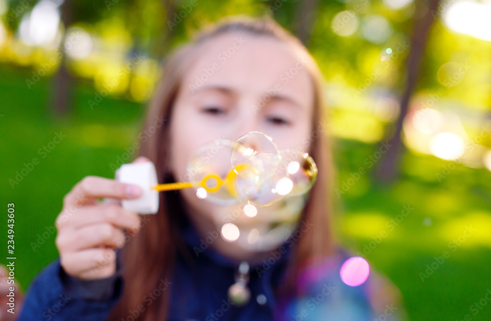 Girls play with soap bubbles.