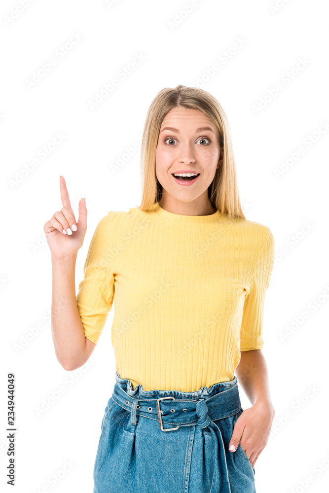 surprised young woman pointing up with finger and smiling at camera isolated on white surprised young woman pointing up with finger and smiling at camera isolated on white