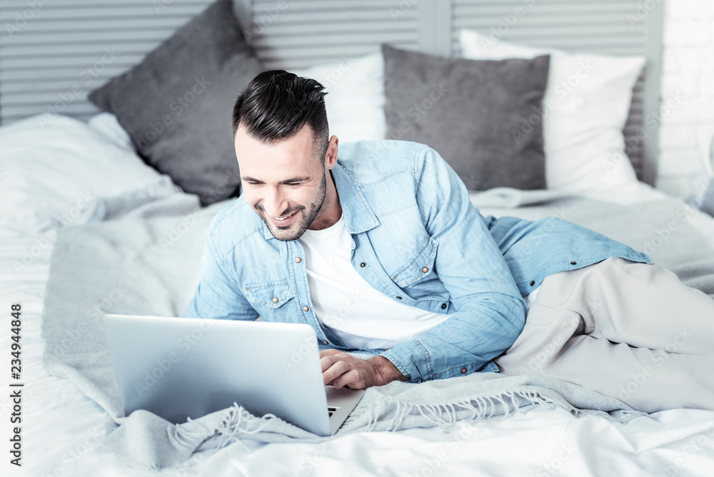 Joyful freelancer chatting in his laptop Joyful freelancer chatting in his laptop