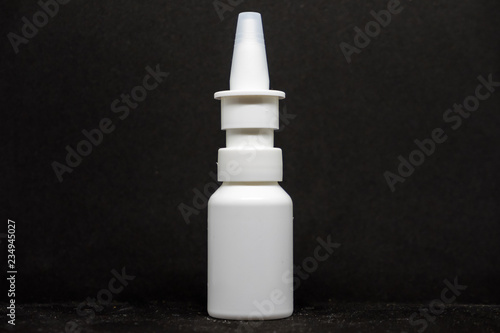 spray for drugs on a black background