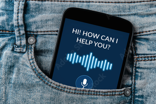 Voice assistant concept on smartphone screen in jeans pocket
