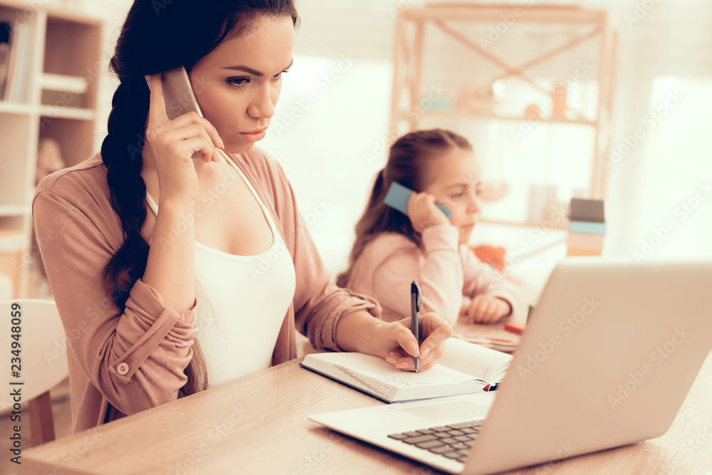 Little Girl Copies Mom with Phone in Hand at Home. Little Girl Copies Mom with Phone in Hand at Home.