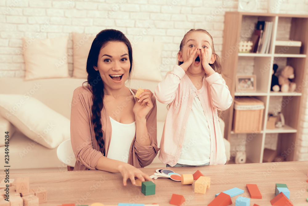 Happy Mom and Daughter Having Fun in Apartment. Happy Mom and Daughter Having Fun in Apartment.