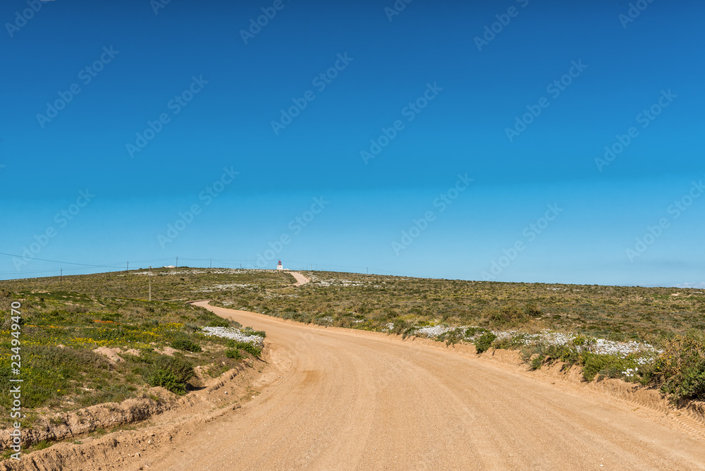 Road to Tietiesbaai near Paternoster. Wild flowers are visible Road to Tietiesbaai near Paternoster. Wild flowers are visible