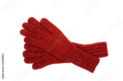 Red gloves with a pattern on a white background. View from above.