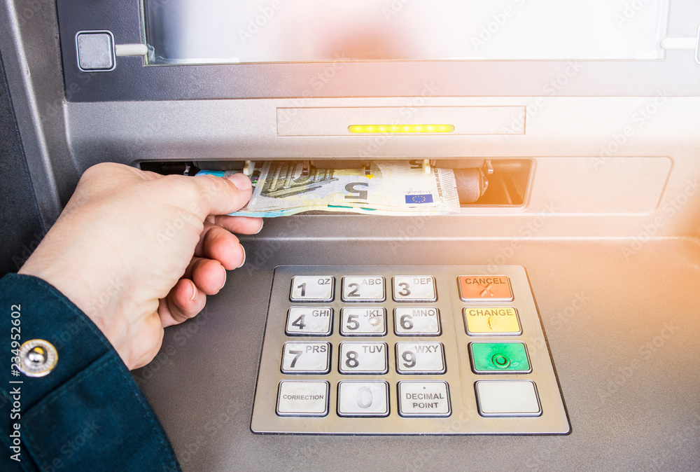 Happy person taking euro money from ATM bank machine. Payday concept. Happy person taking euro money from ATM bank machine. Payday concept.