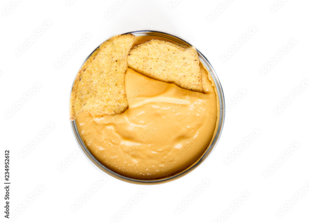 Close up of nachos in a tasty yellow cheddar cheese in a metallic cup, isolated on white. Nacho in cheddar. Close up of nachos in a tasty yellow cheddar cheese in a metallic cup, isolated on white. Nacho in cheddar.