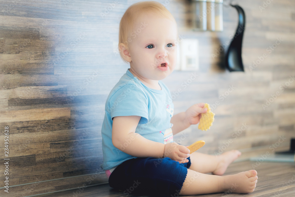 Portrait of little girl eating snacks.sad kid eats cookies Portrait of little girl eating snacks.sad kid eats cookies