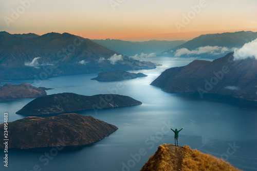 New Zealand, South Island, Wanaka, Otago, Woman on Coromandel peak at sunrise photo