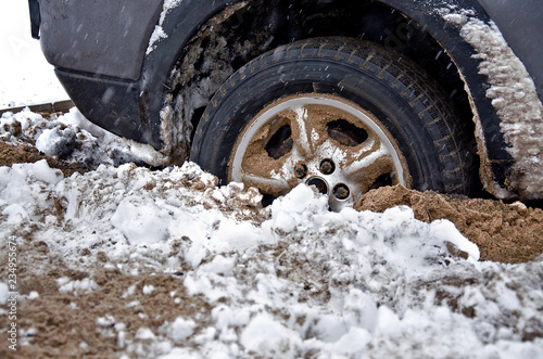 car wheel is deeply stuck in the sand