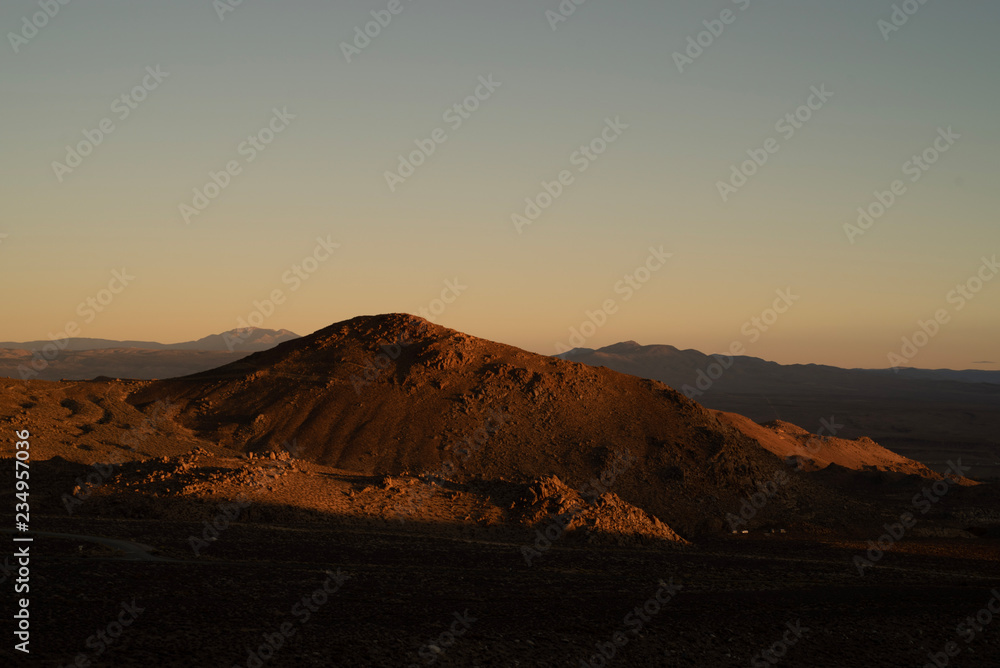 golden morning light on red earth hill, mountains, Eastern Sierra Nevada, California, USA