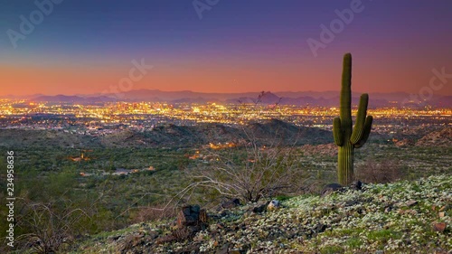 South Western Landscape Timelapse at Dusk over the City Lights of Phoenix Arizona under a Vibrant Orange Pink and Blue Sky photo