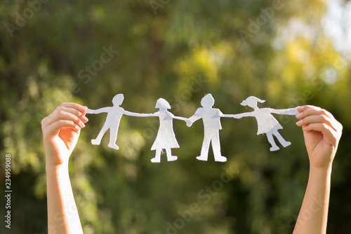 Holding a paper doll family photo