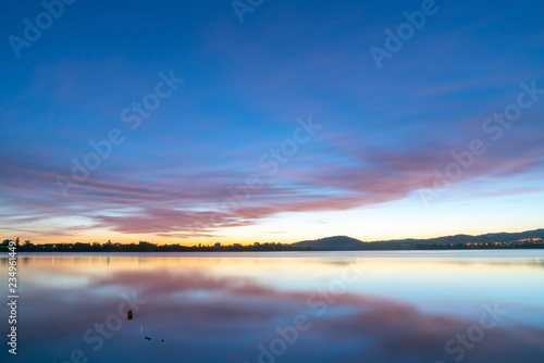Calming effect of long exposure sunrise over bay in pink and blue hues. © Brian Scantlebury
