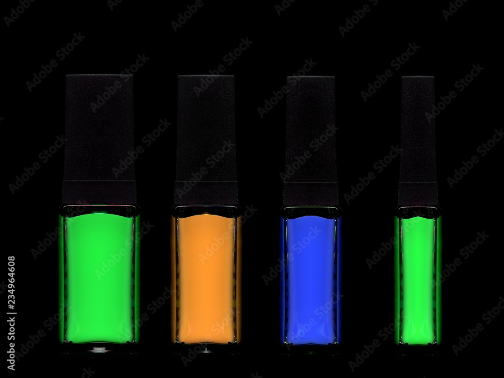 Bright multi-colored nail polishes on a black background. Bright multi-colored nail polishes on a black background.
